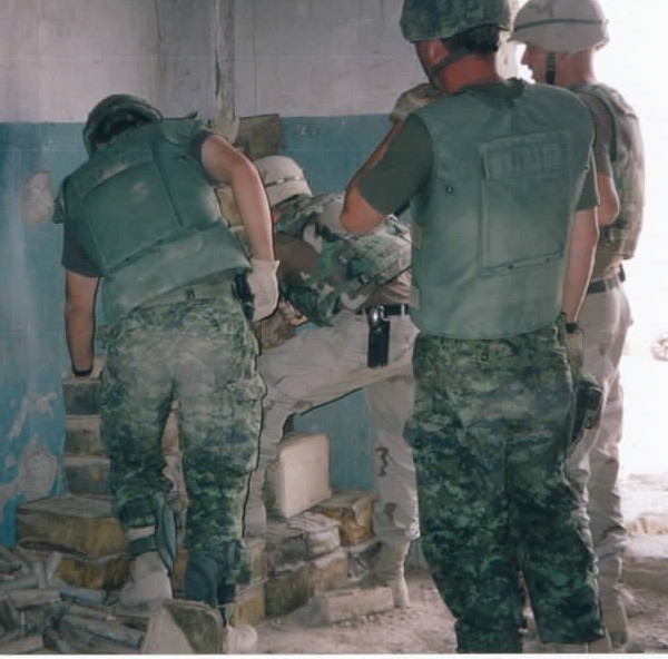 Canadian and American combat engineers find booby-trap in ammunition cache